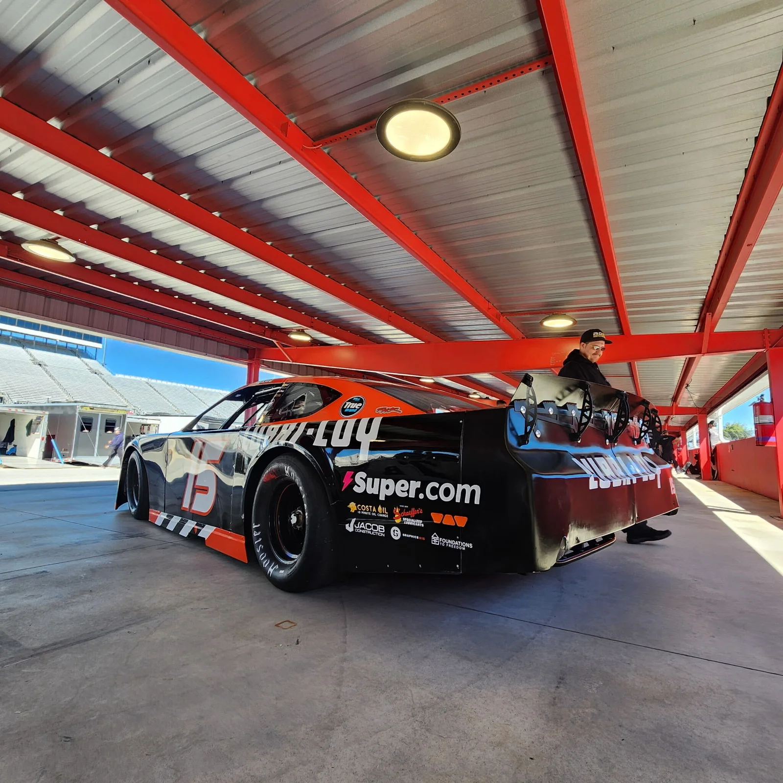Lubri-Loy-branded No. 15 race car in the garage